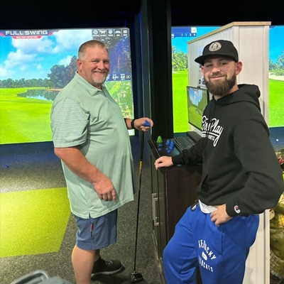 Golfers playing under the bay lights