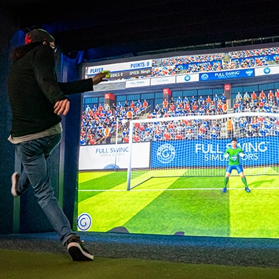 Simulator bay in use with a fairway on screen
