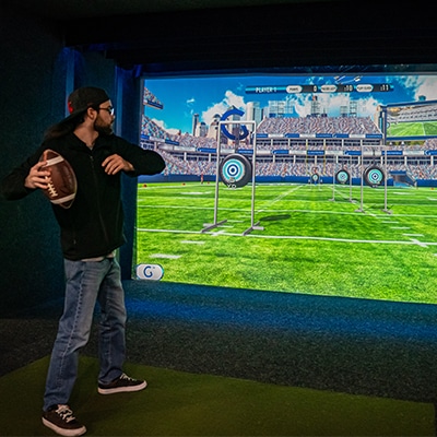 Member mid-swing in the simulator bay
