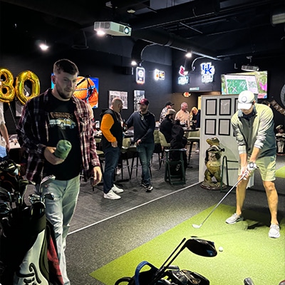 Player finishing a driver swing in the bay